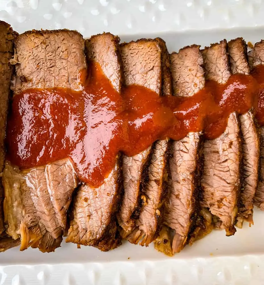 Instant Pot Beef Brisket with BBQ Sauce on a white plate