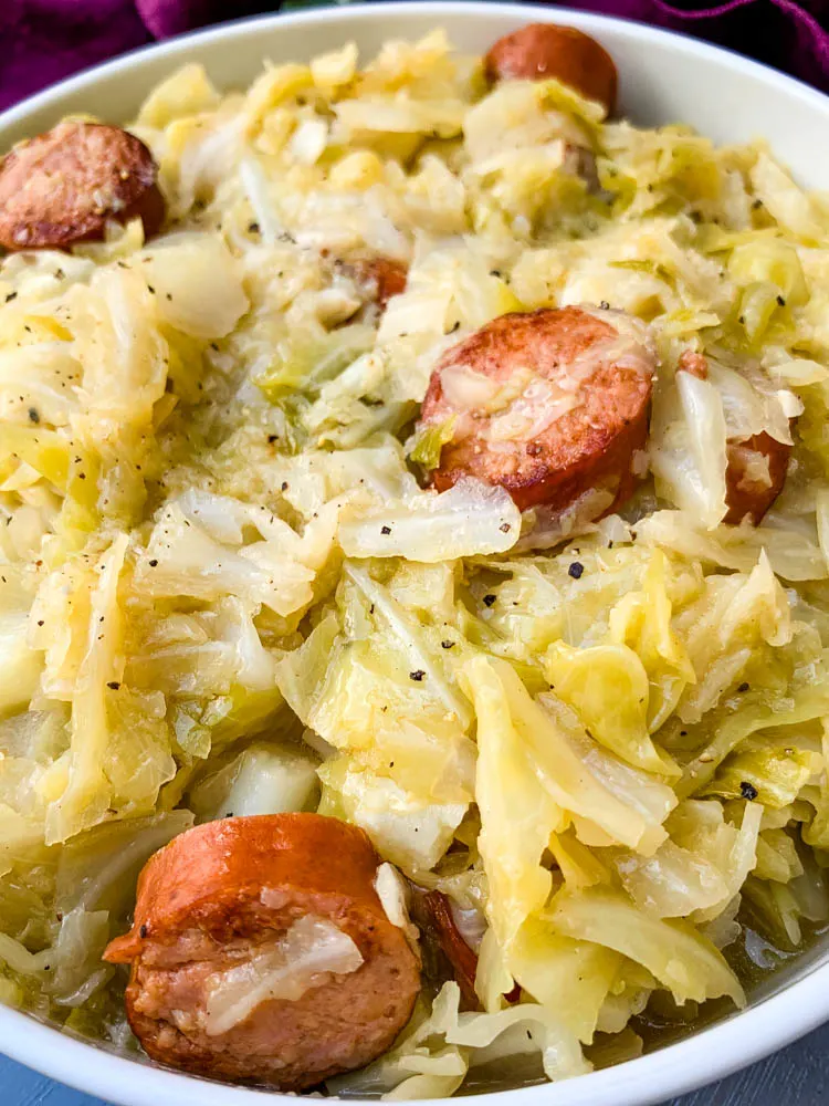 instant pot cabbage and sausage in a white bowl
