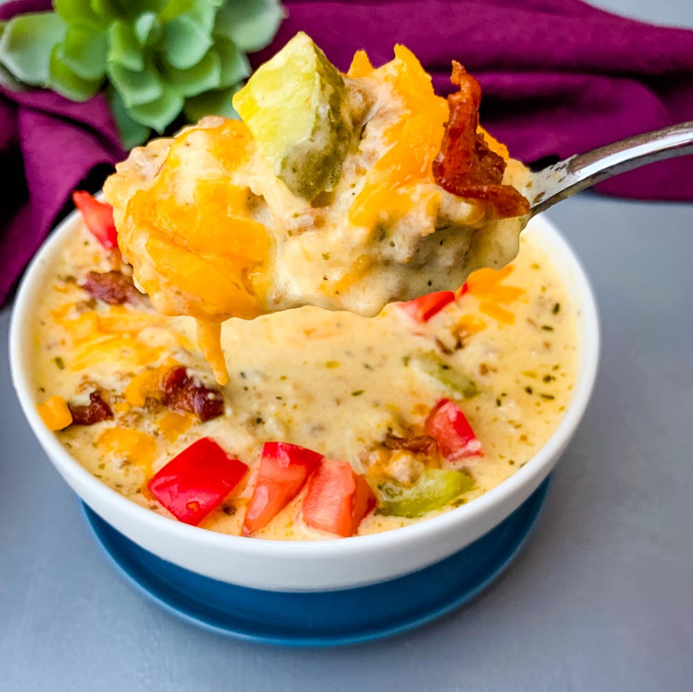 spoonful of keto cheeseburger soup with bacon, pickles, and tomatoes