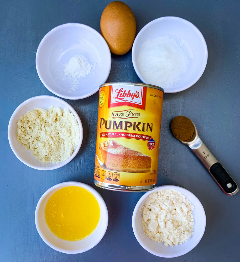 sweetener, baking powder, almond flour, coconut flour, pumpkin, pumpkin pie sauce, melted butter, and an egg for keto low carb pumpkin mug cake