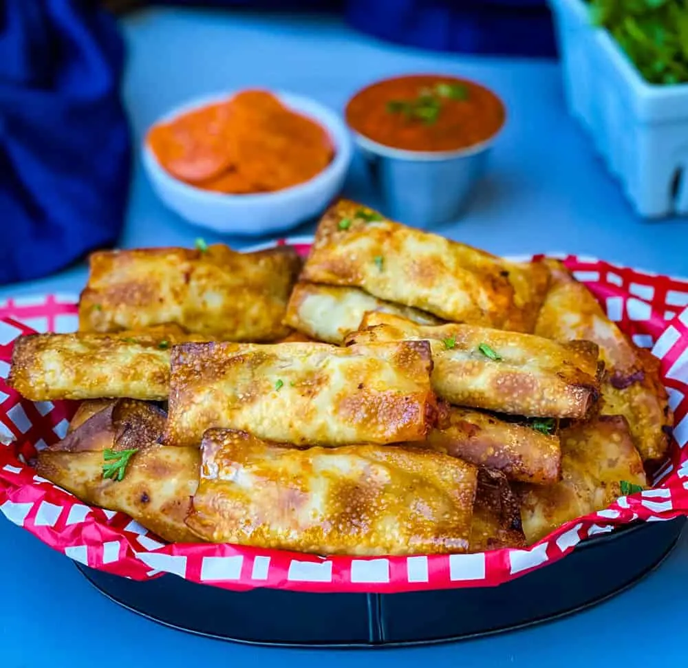 air fryer pizza rolls in a black bowl with pepperoni and marinara sauce