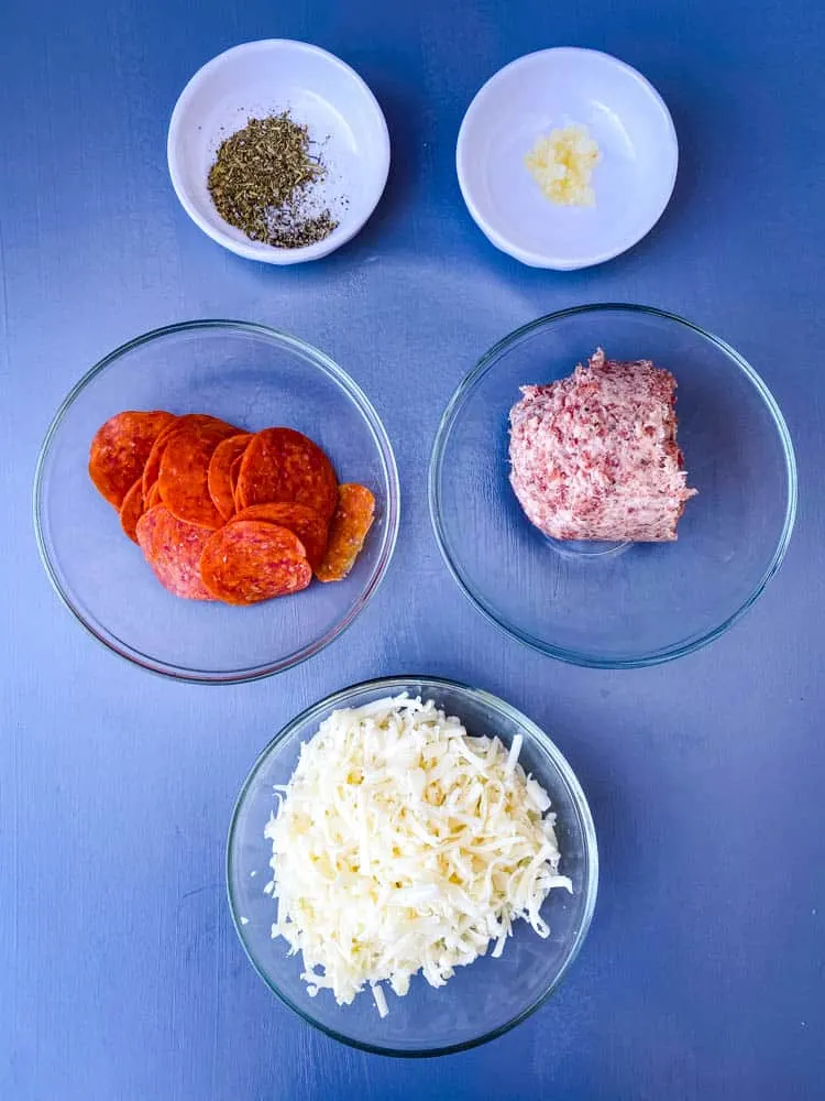 shredded mozzarella, pepperoni, ground sausage, Italian seasoning, and garlic for air fryer pizza rolls recipe