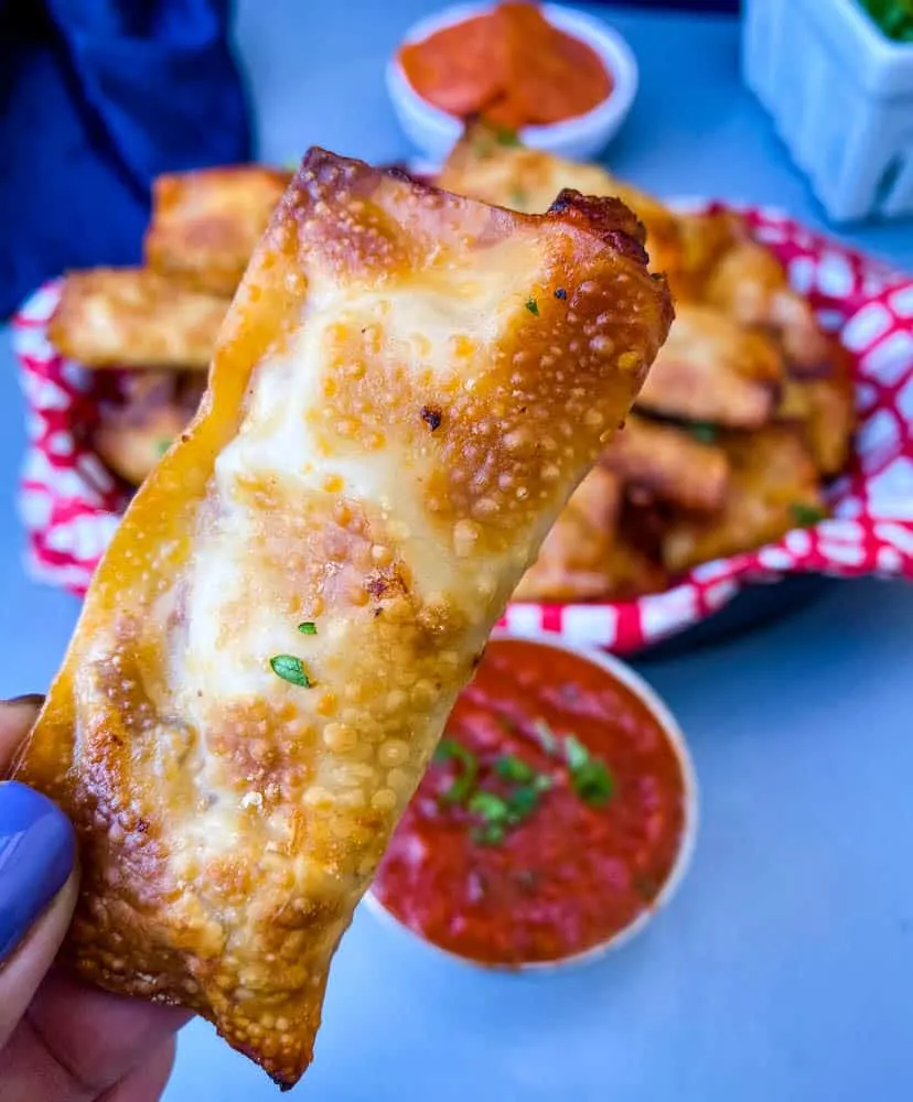 close up photo of person holding air fryer pizza roll