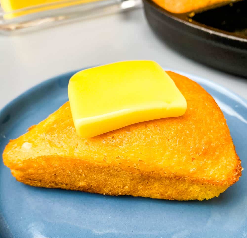 keto low carb cornbread with butter on a blue plate