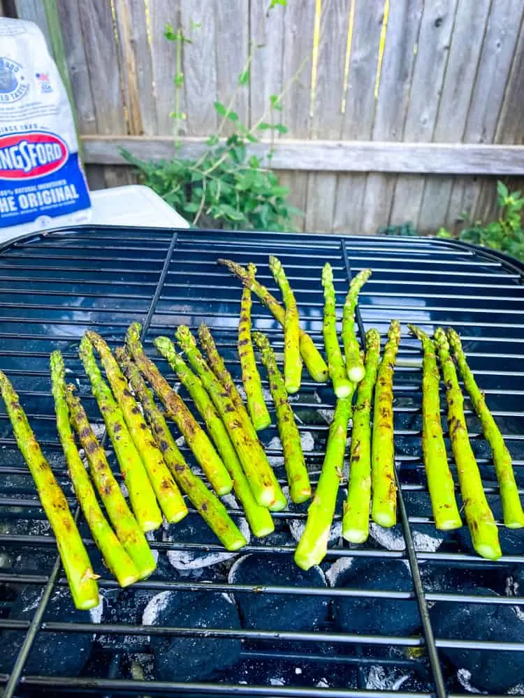 asparagus grilling on a charcoal grill