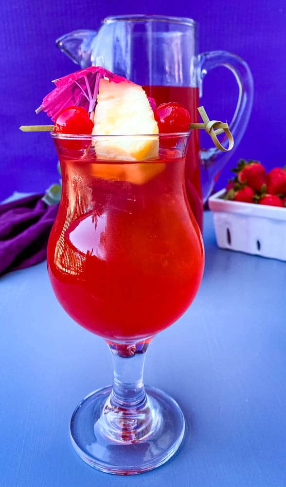 easy rum punch recipe in glasses with pineapple and cherries