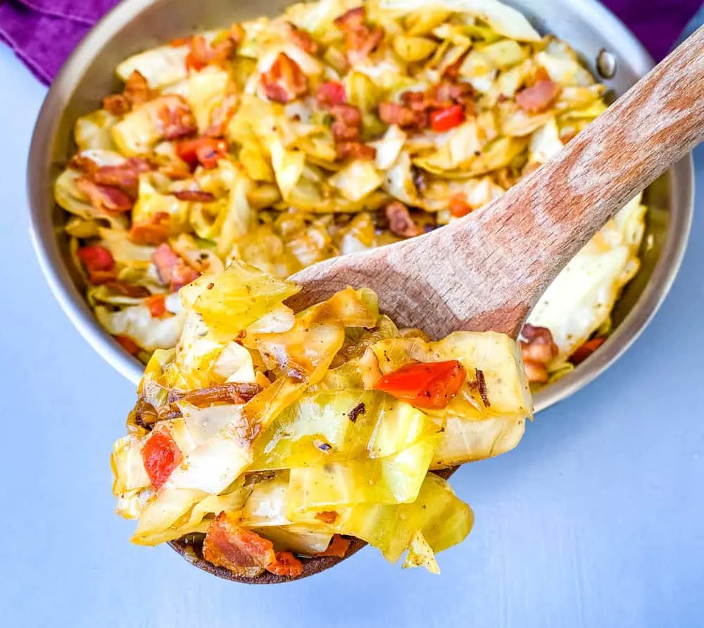 southern fried cabbage in a wooden spoon