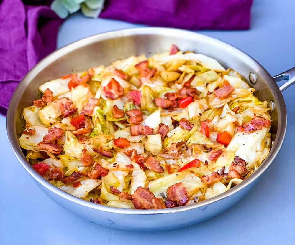 southern fried cabbage with bacon in a stainless steel pan