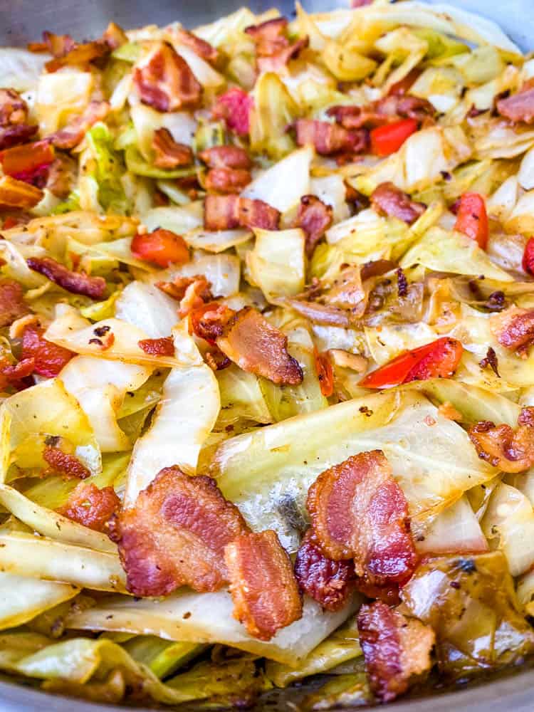 southern fried cabbage with bacon in a stainless steel pan