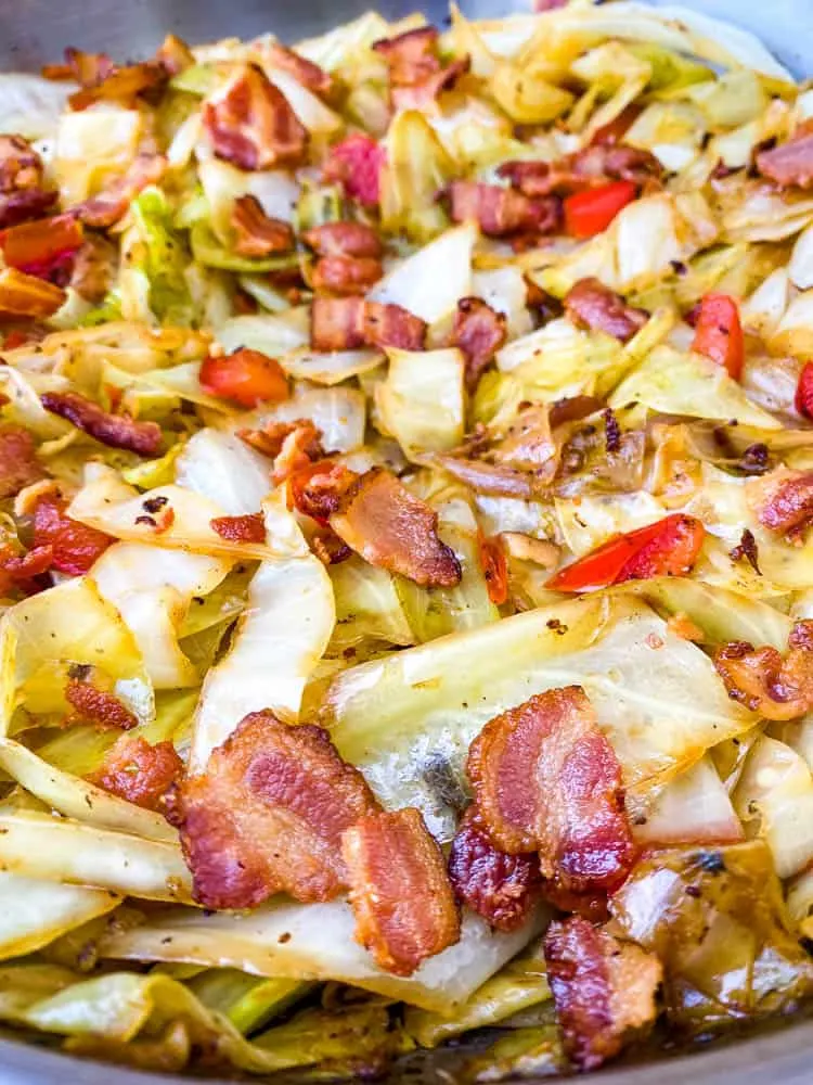 southern fried cabbage with bacon in a stainless steel pan