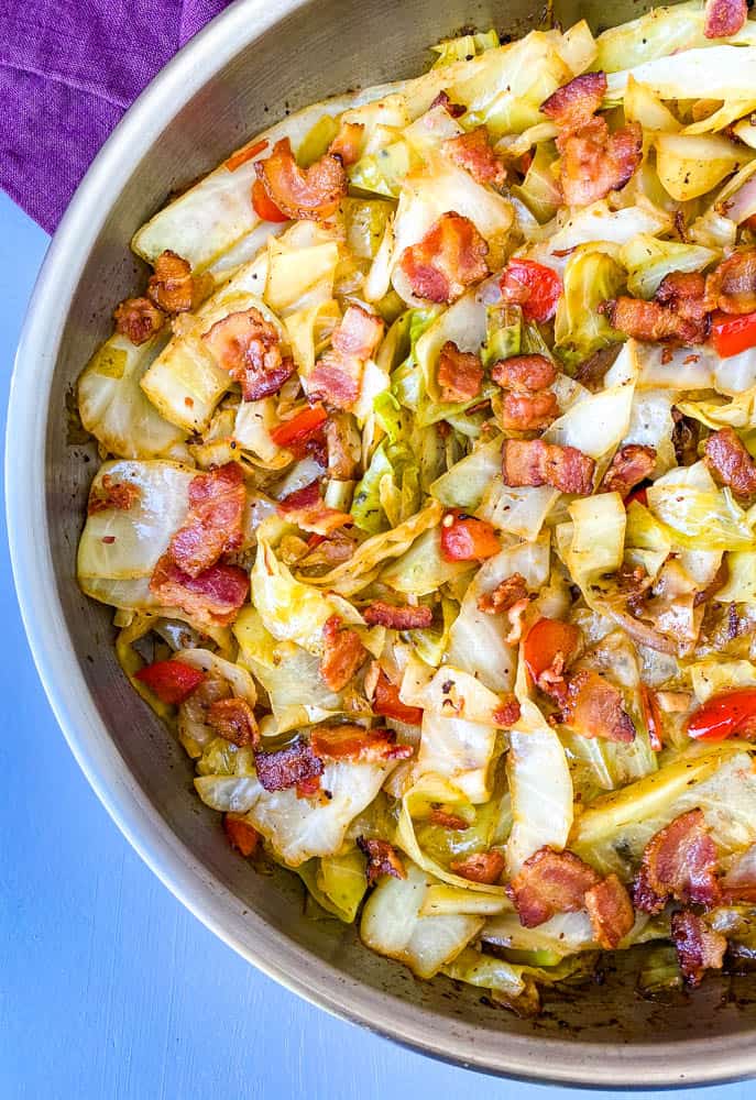 southern fried cabbage with bacon in a stainless steel pan