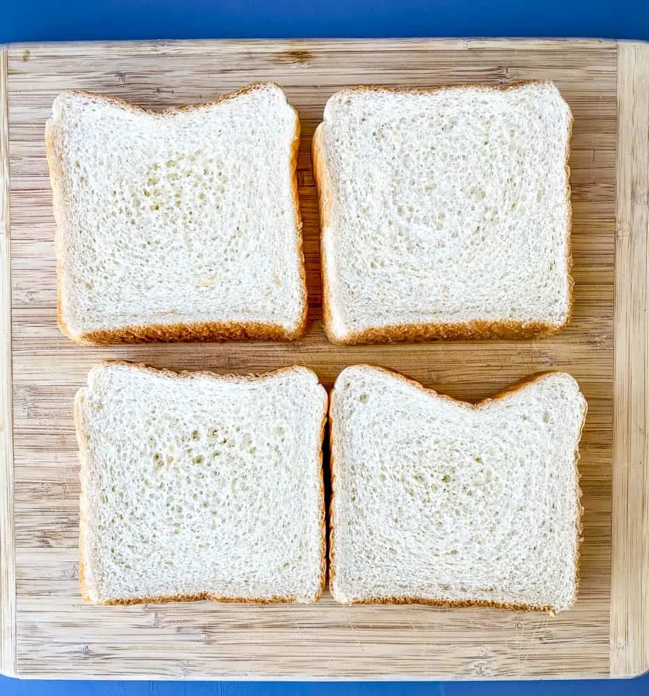 4 slices of Texas toast bread on a wooden cutting board