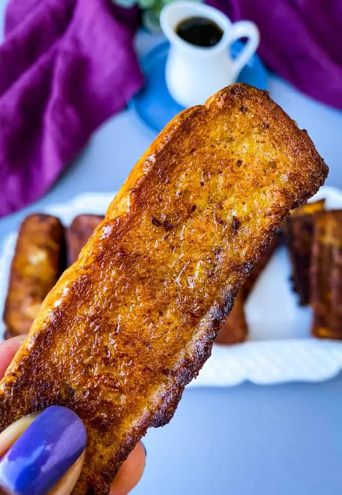 person holding air fryer French toast stick