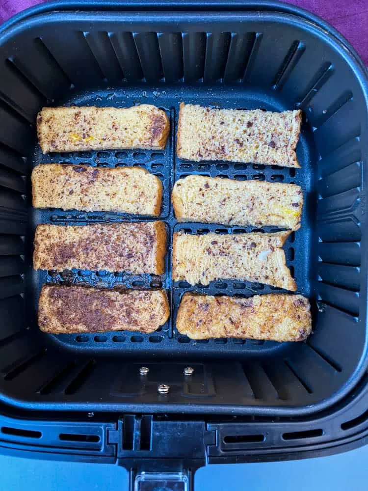 uncooked French toast sticks in an air fryer