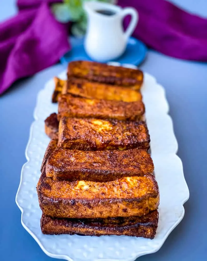 air fryer French toast sticks on a white plate
