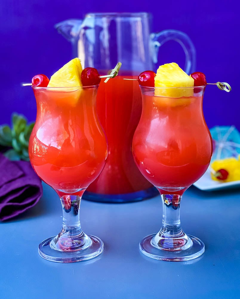 Bahama Mama Recipe in glasses with a pitcher of drink