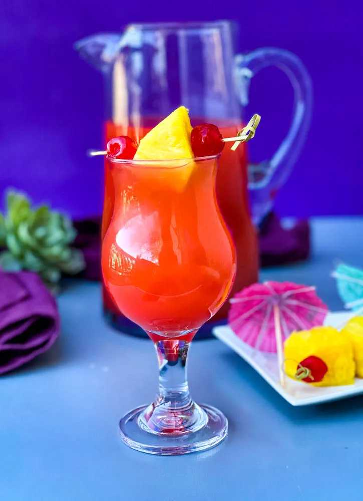 Bahama Mama Recipe in glasses with a pitcher of drink