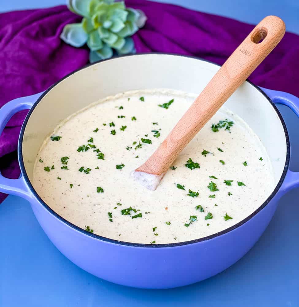 keto low carb roasted cauliflower soup in a purple Dutch oven