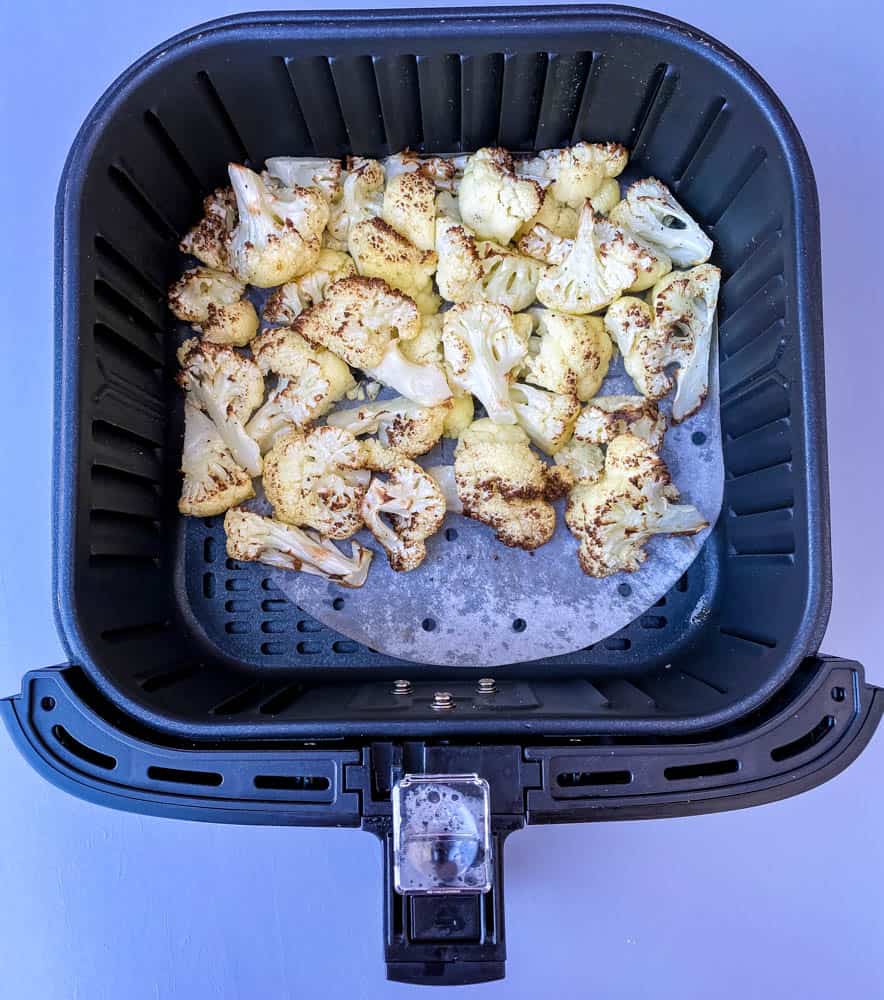 roasted cauliflower in an air fryer basket