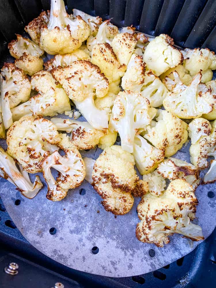 roasted cauliflower in an air fryer basket