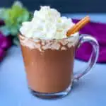 keto low carb hot chocolate in a glass mug with whipped cream and cinnamon