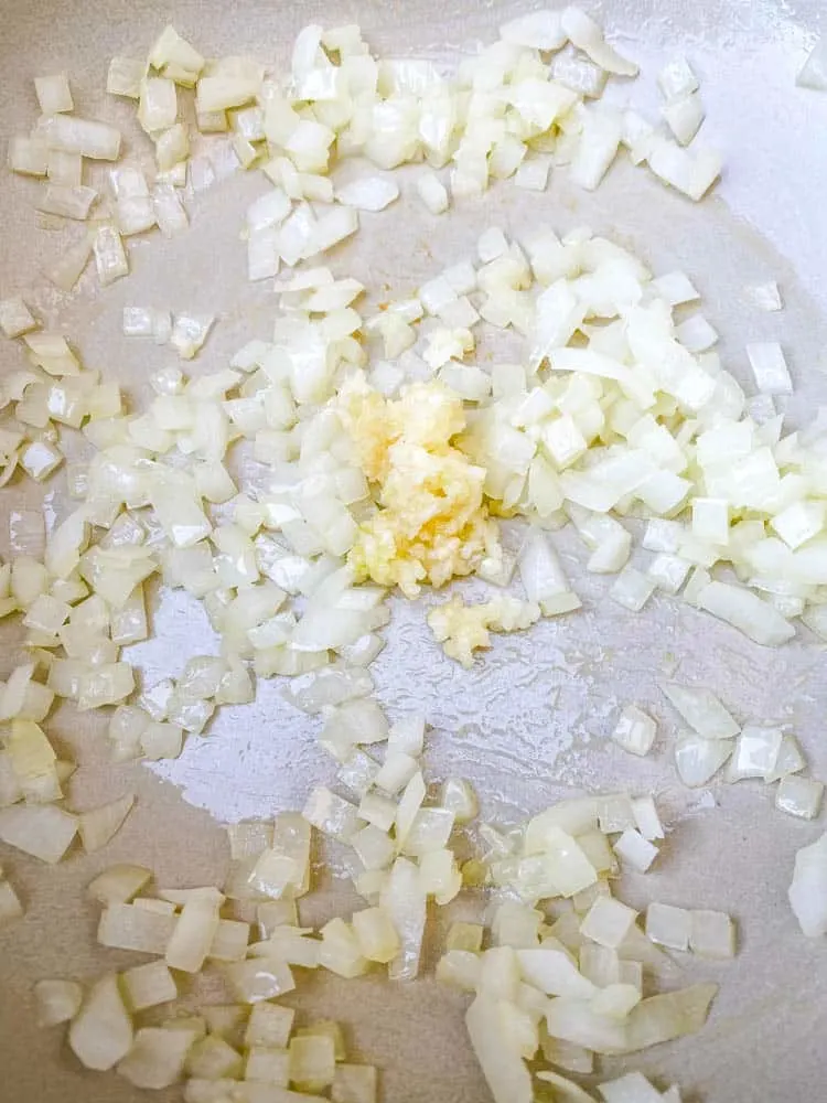 chopped onions and garlic in a Dutch Oven for keto low carb marinara sauce