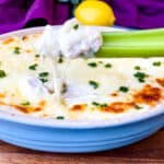 celery with crab rangoon dip in a blue baking dish