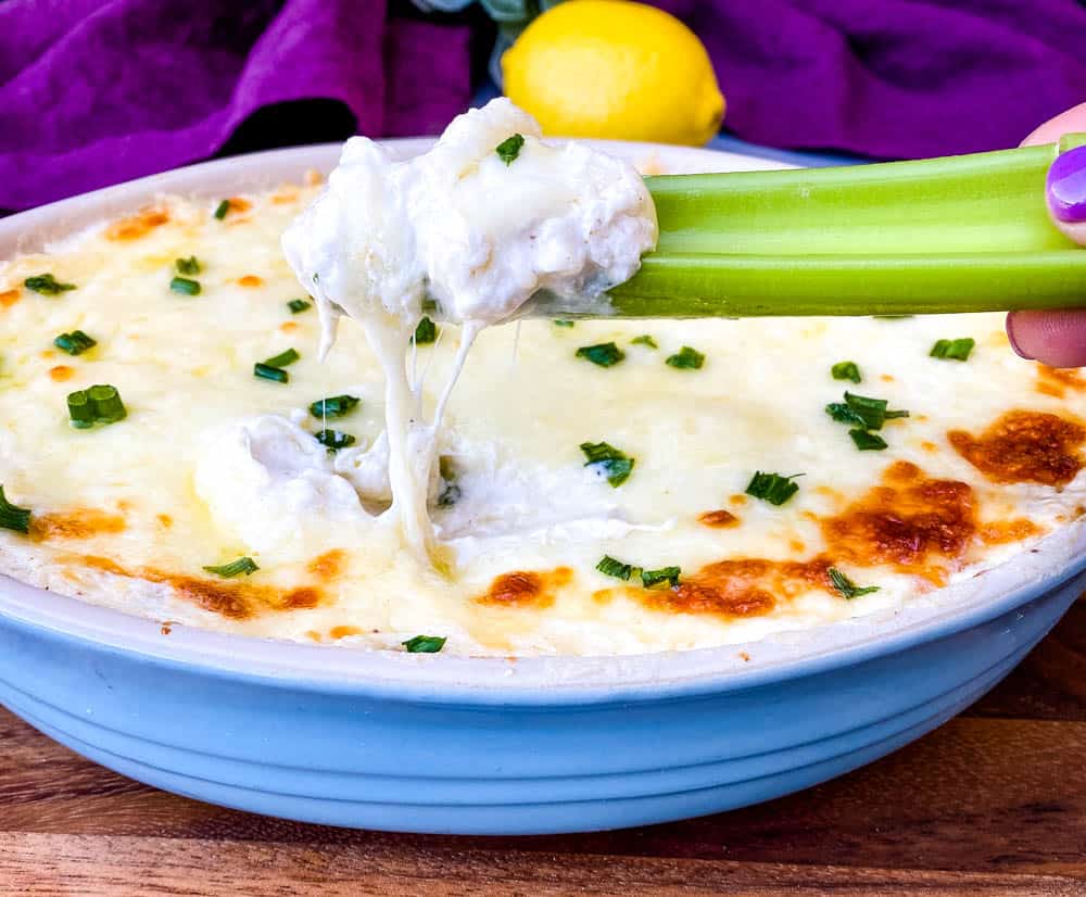 celery with crab rangoon dip in a blue baking dish