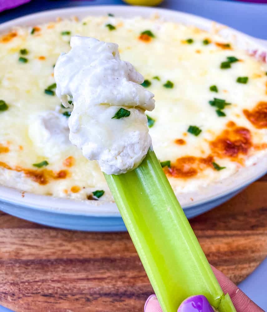 celery with crab rangoon dip in a blue baking dish