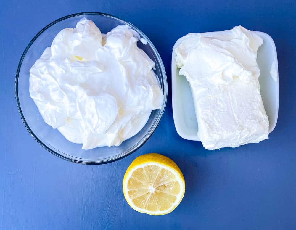 sour cream, cream cheese in glass bowls and a fresh lemon for crab rangoon dip