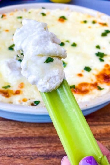 celery with crab rangoon dip in a blue baking dish