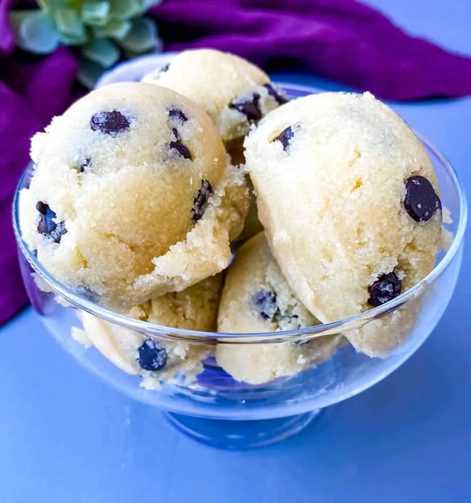 keto low carb chocolate chip cookie dough bites in a glass bowl with a purple napkin