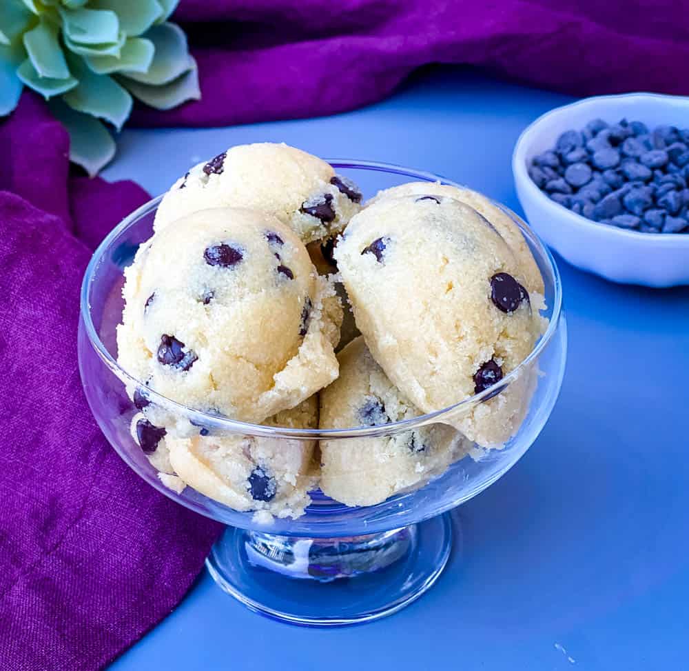 keto low carb chocolate chip cookie dough bites in a glass bowl with a purple napkin
