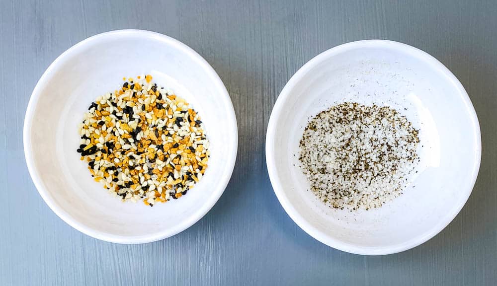 Everything But The Bagel Seasoning, salt, and pepper in small white bowls