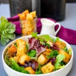 air fryer croutons on a salad in a white bowl