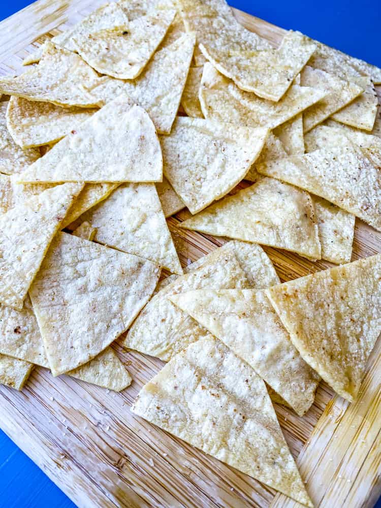 sliced corn tortillas on a cutting board for air fryer tortilla chips