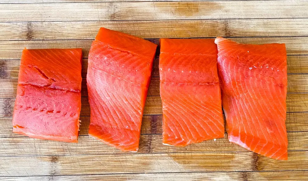 raw wild caught salmon on a cutting board