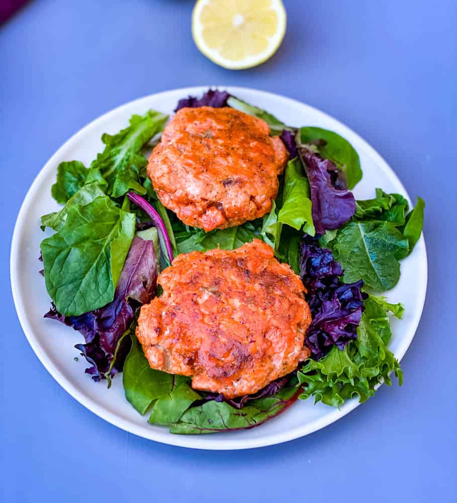 keto low carb salmon patties on a plate with mixed greens