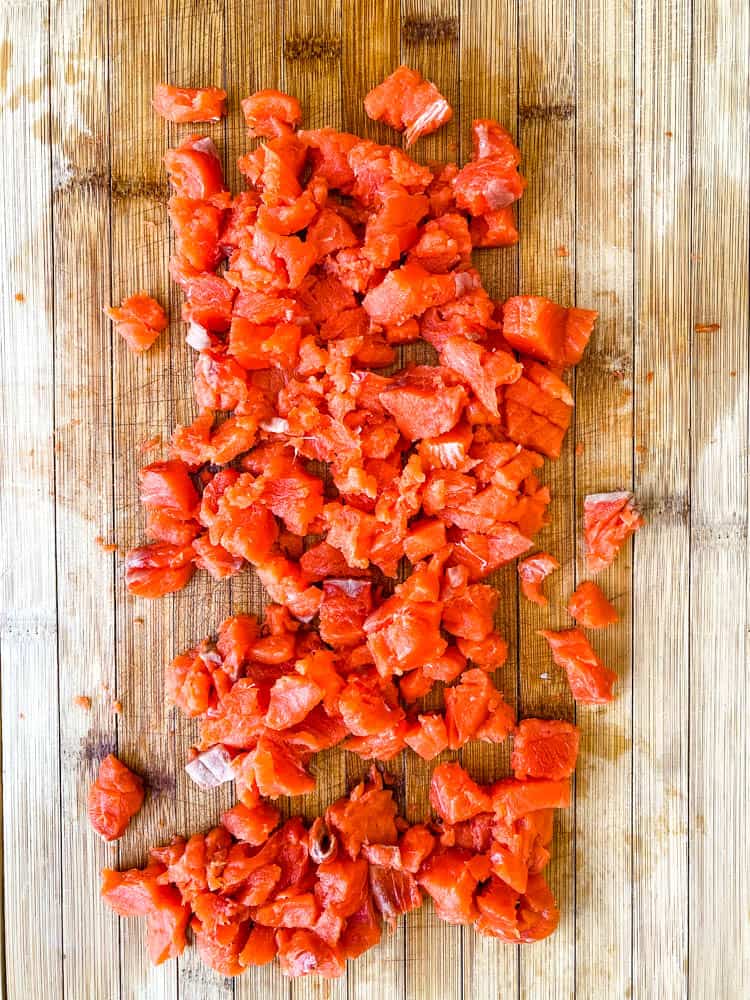 wild caught salmon diced on a cutting board