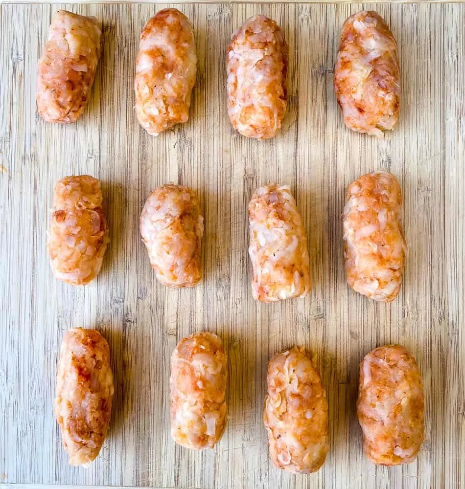 uncooked air fryer tater tots on a cutting board