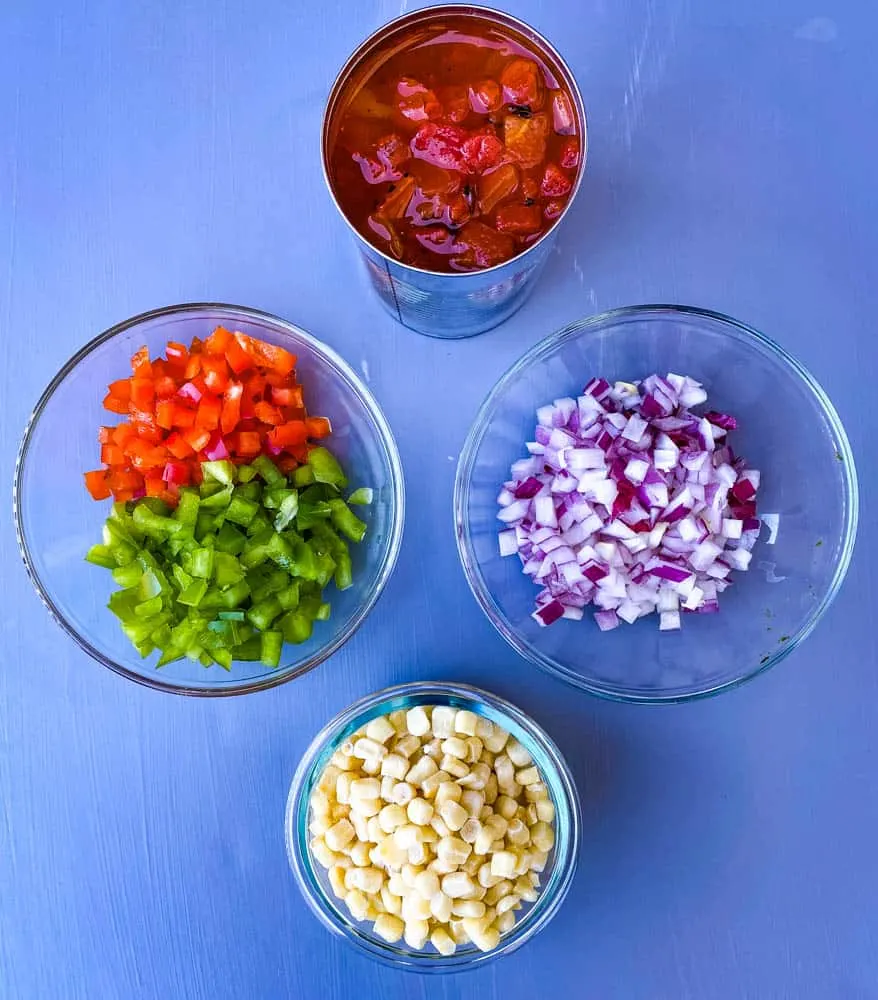 diced tomatoes, red pepper, green peppers, chopped onions, and corn in separate bowls