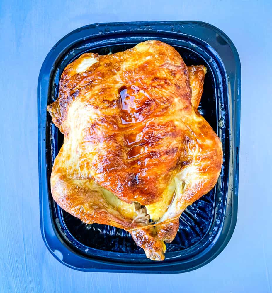 cooked rotisserie chicken on a black plate