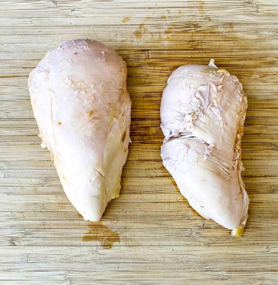 cooked chicken breasts on a bamboo cutting board