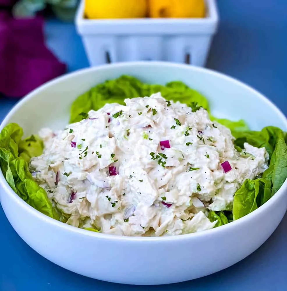 keto chicken salad on a bed of lettuce in a white bowl