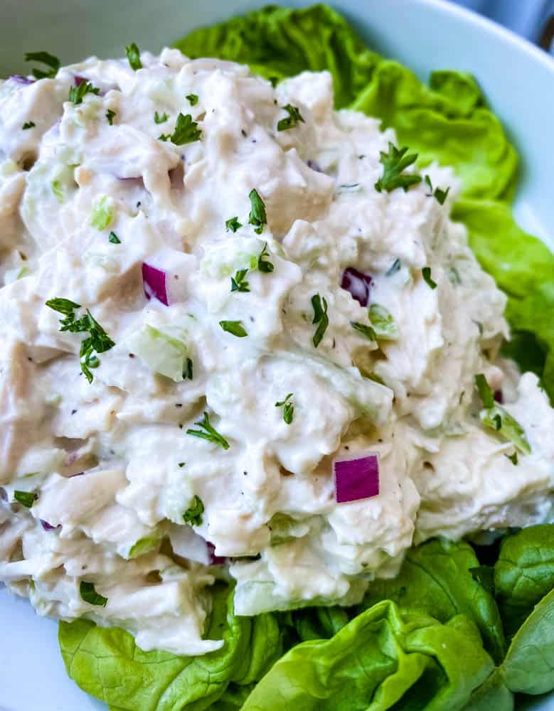 keto chicken salad on a bed of lettuce in a white bowl