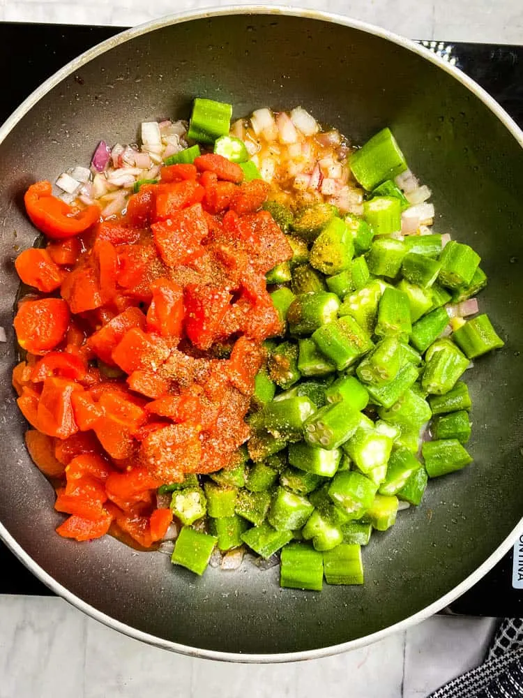 diced tomatoes and frozen okra in a skillet