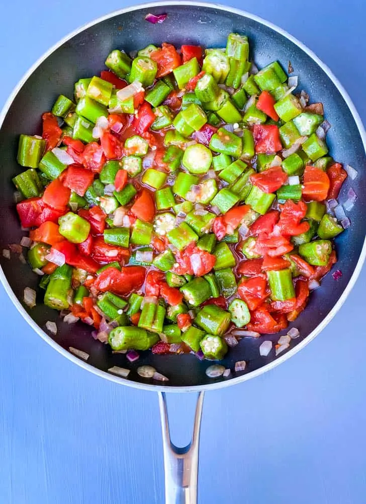 diced tomatoes and frozen okra in a skillet