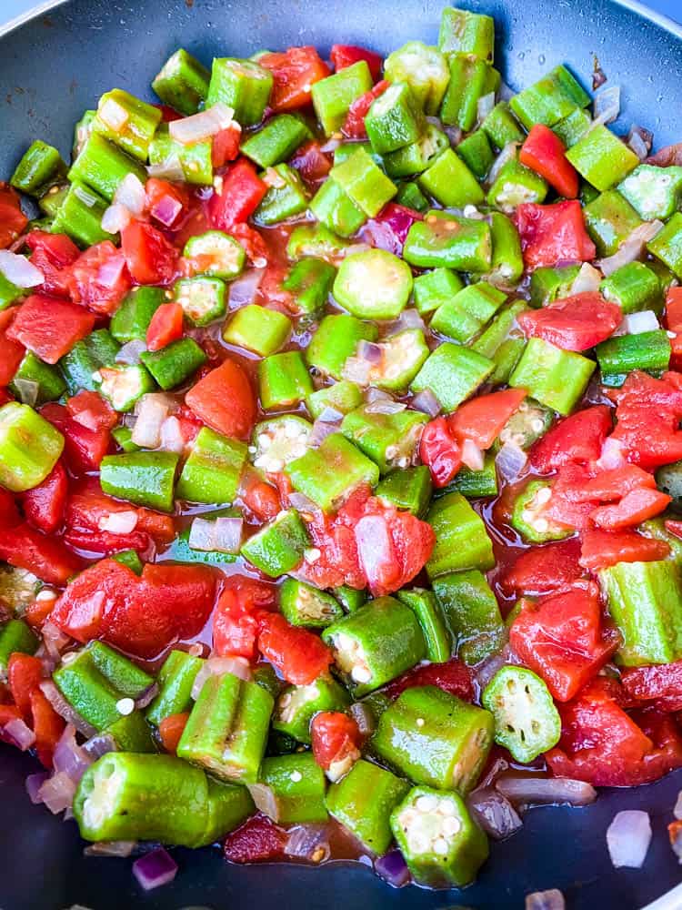 diced tomatoes and frozen okra in a skillet