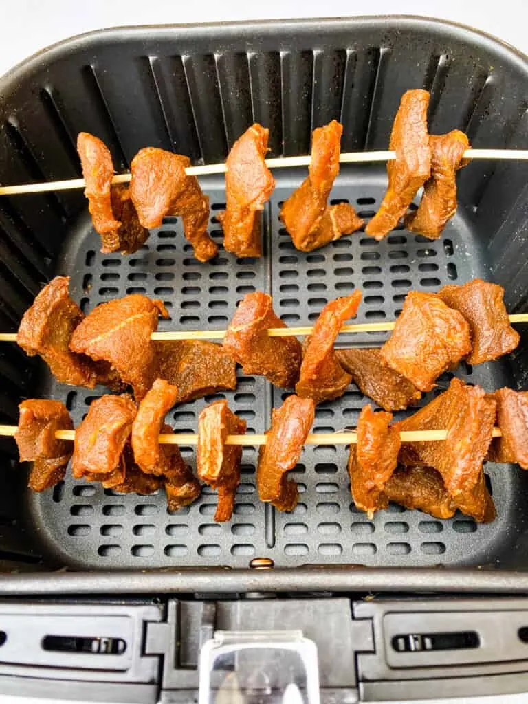 beef jerky on bamboo skewers in an air fryer