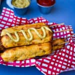 air fryer corn dogs in a basket with a red and white napkin